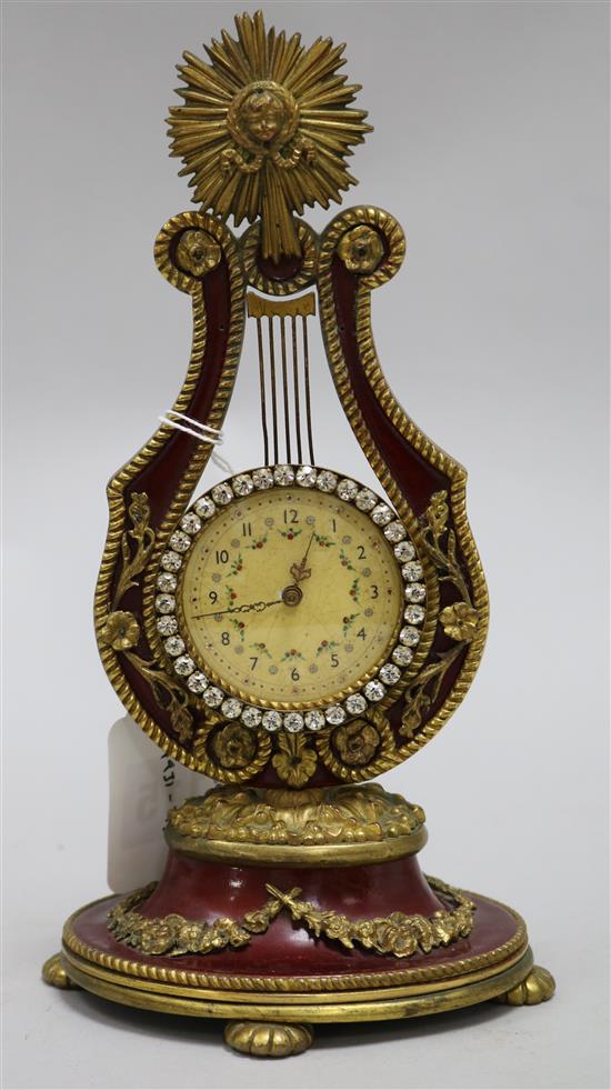 A French enamelled gilt metal lyre shaped timepiece, 22cm